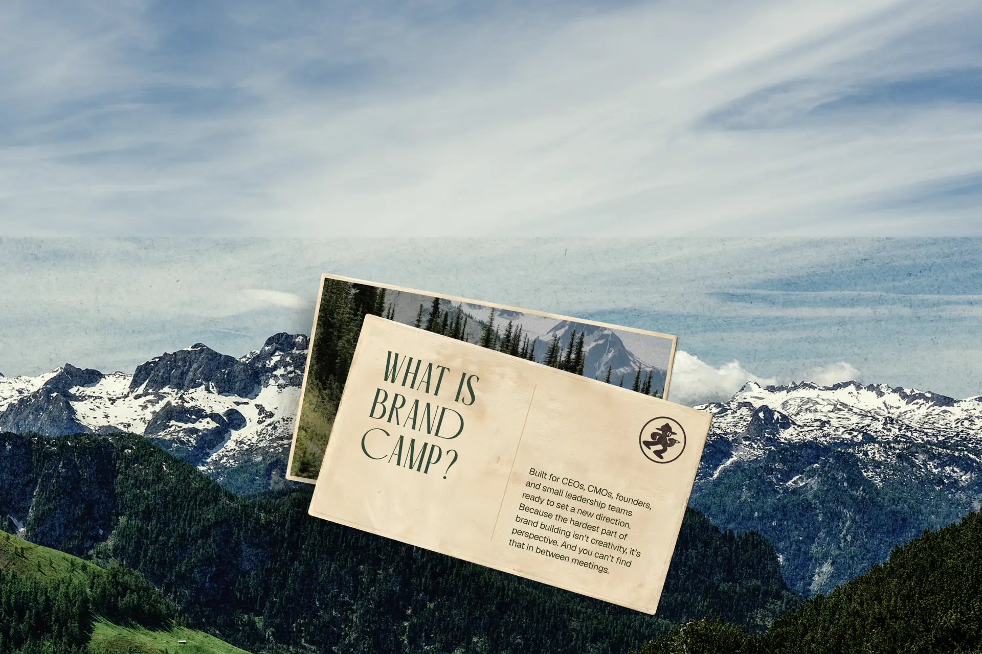 Mountain landscape with postcards reading What is Brand Camp